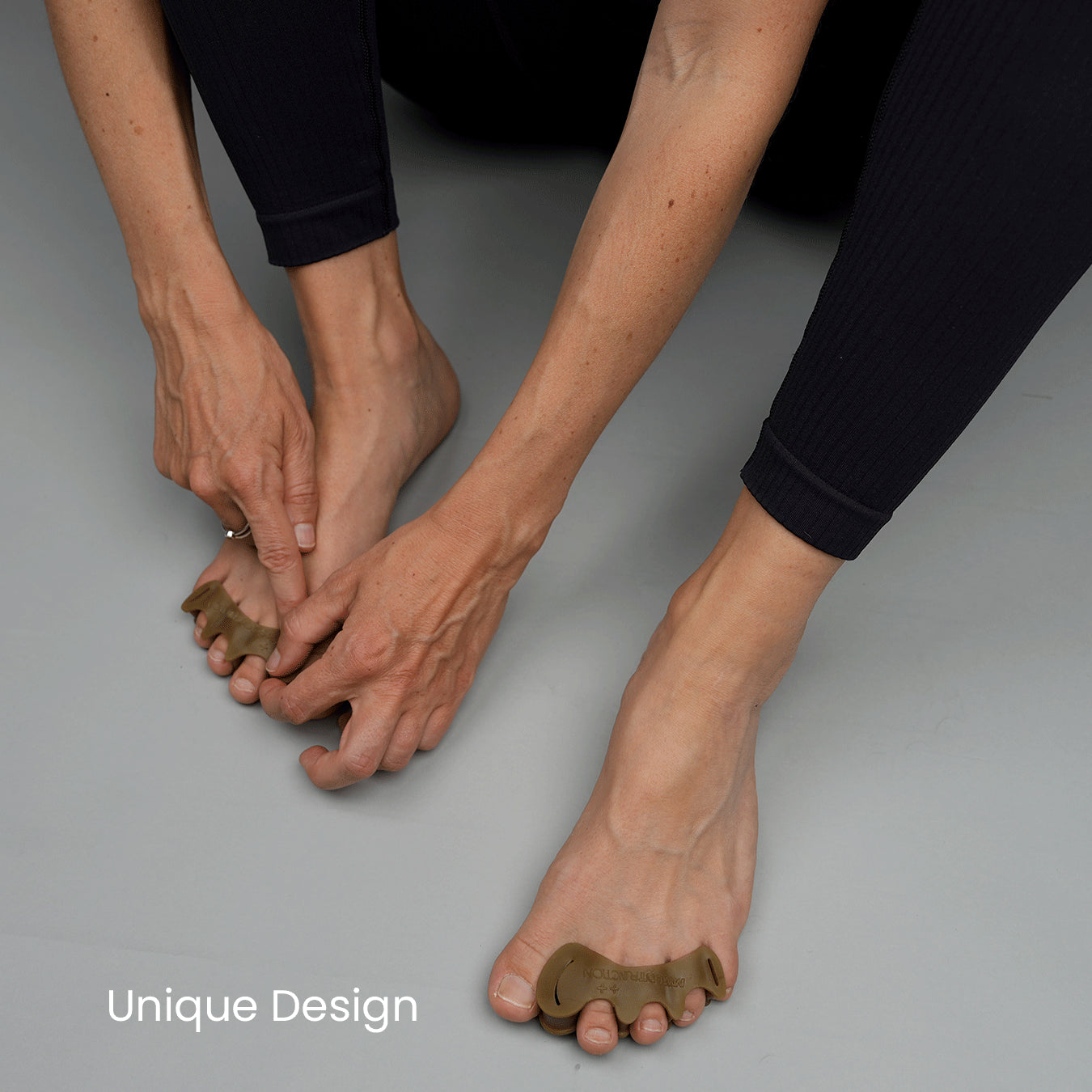 Fitting a toe spacer onto a bare foot